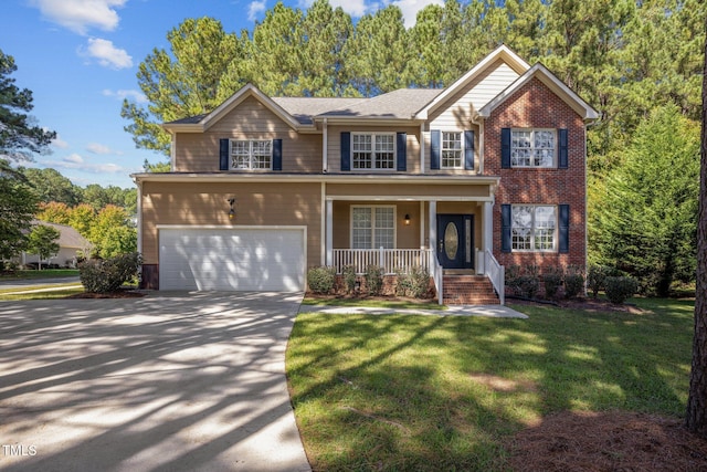 view of front of house featuring a front yard, a garage, and a porch