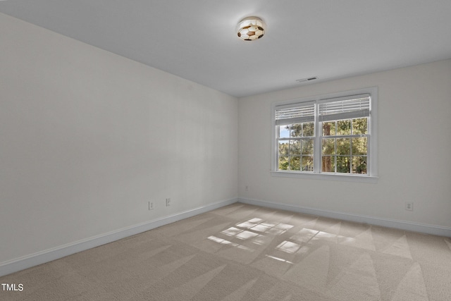 unfurnished room with light carpet