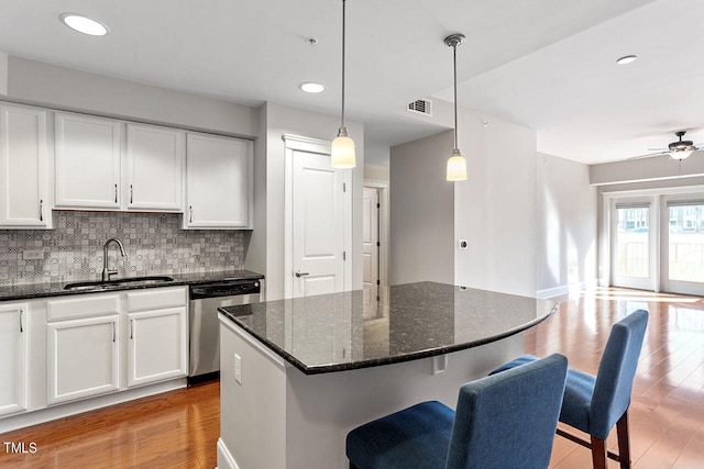 kitchen with sink, stainless steel dishwasher, and white cabinets