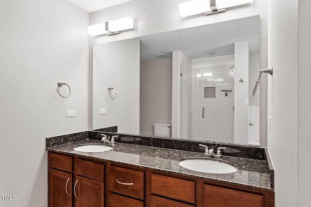 bathroom featuring vanity, an enclosed shower, and toilet