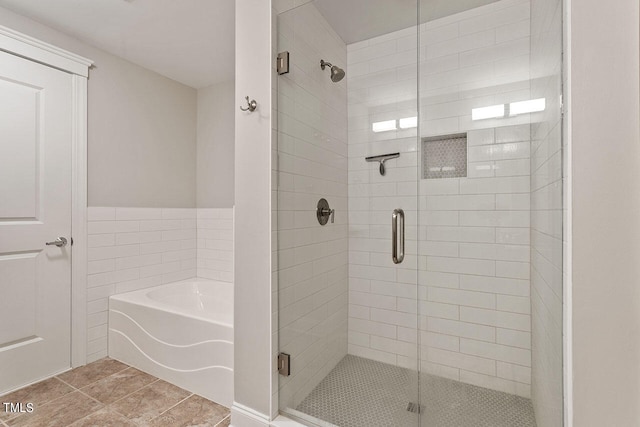 bathroom featuring tile patterned flooring and plus walk in shower