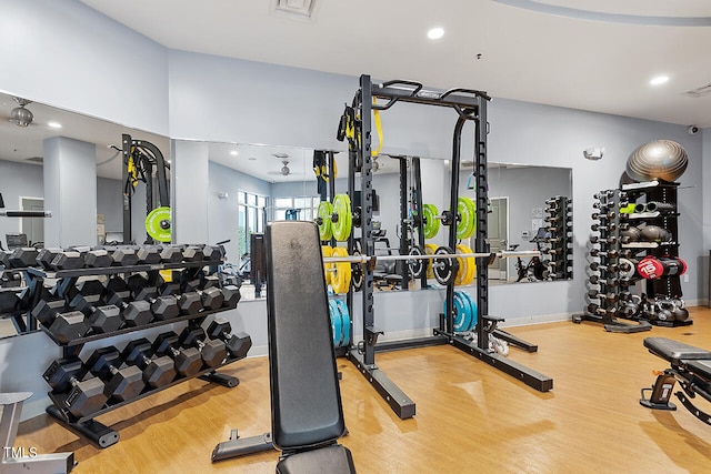 exercise room with hardwood / wood-style flooring