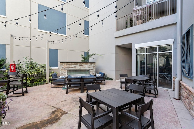 view of patio / terrace with an outdoor living space with a fireplace