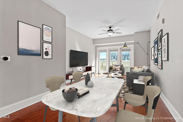 dining area with a ceiling fan, baseboards, visible vents, and wood finished floors
