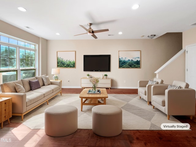 living room featuring ceiling fan and light hardwood / wood-style flooring