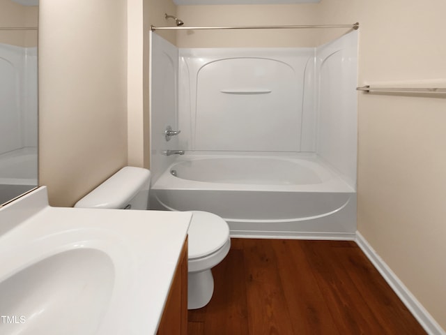 full bathroom featuring hardwood / wood-style floors, vanity,  shower combination, and toilet