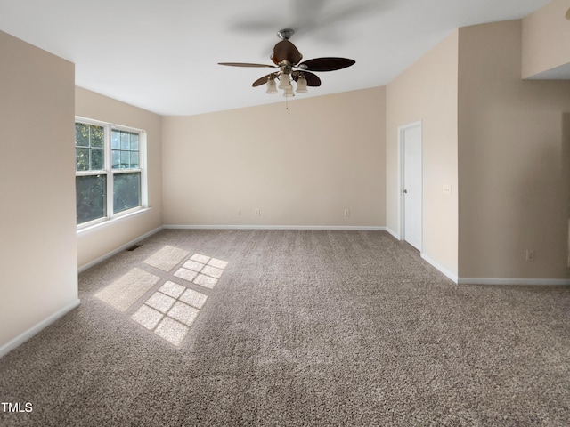 carpeted empty room featuring ceiling fan