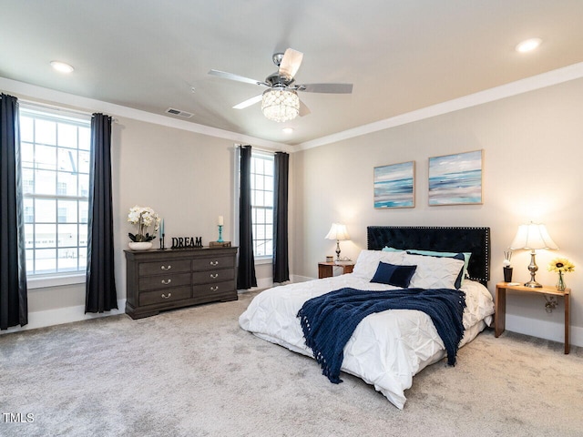 bedroom with ceiling fan, light colored carpet, crown molding, and multiple windows