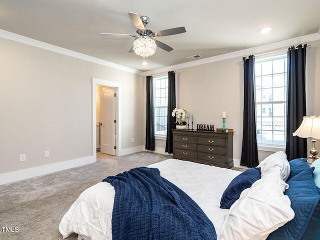 carpeted bedroom with ceiling fan and ornamental molding