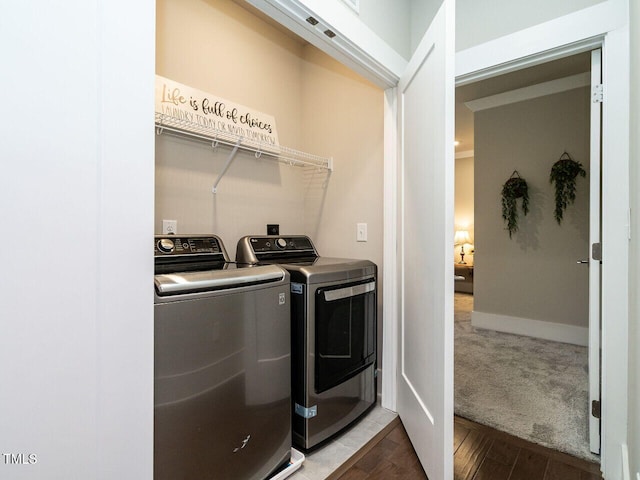 laundry area with wood-type flooring and washer and clothes dryer