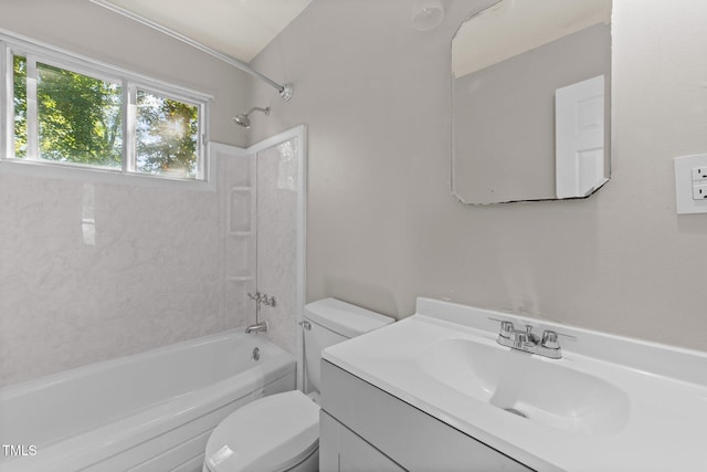 full bathroom featuring tiled shower / bath, vanity, and toilet