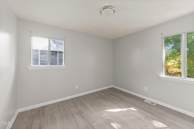 spare room with light wood-type flooring