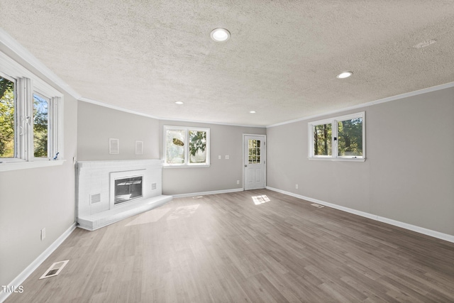 unfurnished living room with a fireplace, plenty of natural light, and hardwood / wood-style floors