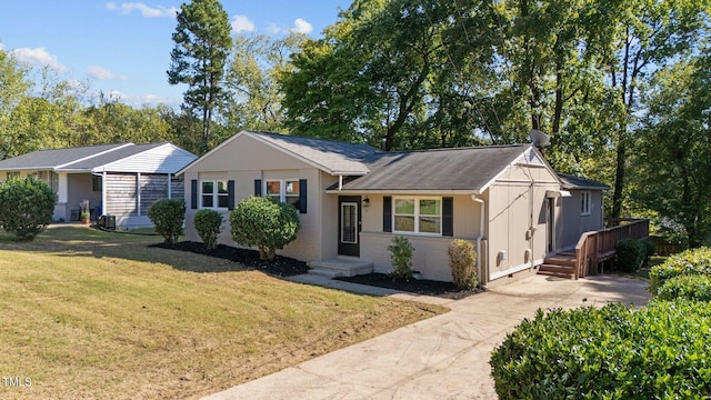 ranch-style home with a front yard and a wooden deck