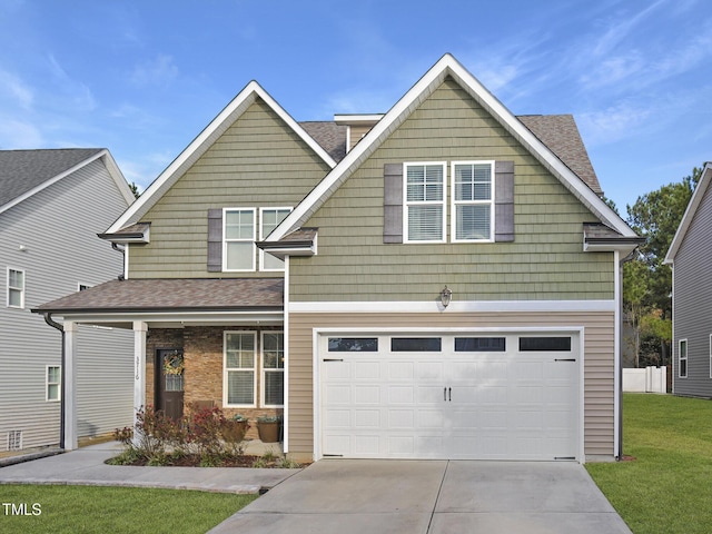 view of front of property featuring a front yard, a garage, and a porch