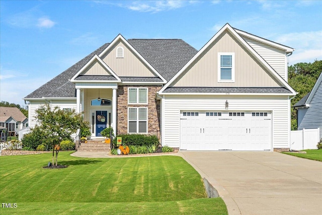 craftsman house featuring a front lawn and a garage