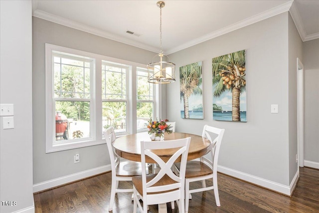 dining area with an inviting chandelier, ornamental molding, and dark hardwood / wood-style flooring