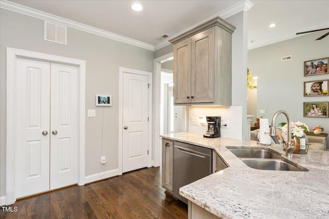 kitchen featuring light stone countertops, dark hardwood / wood-style floors, sink, and stainless steel dishwasher