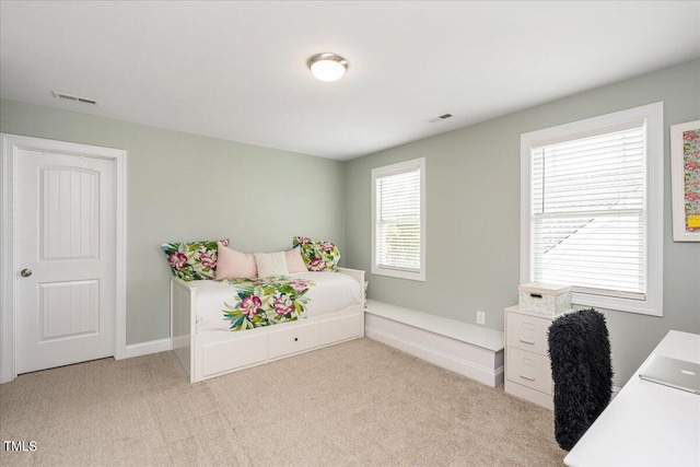 bedroom featuring light carpet