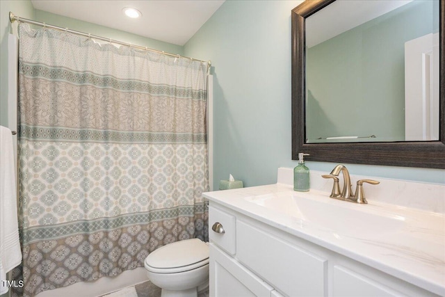 bathroom featuring toilet, walk in shower, and vanity