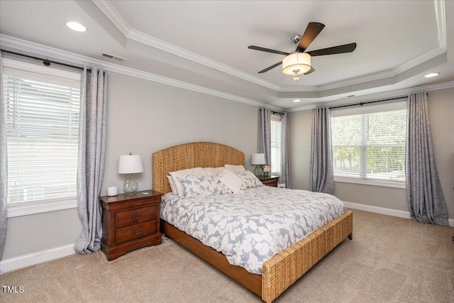 carpeted bedroom featuring ornamental molding, ceiling fan, and a raised ceiling