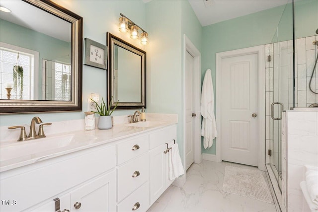 bathroom with vanity and a shower with door