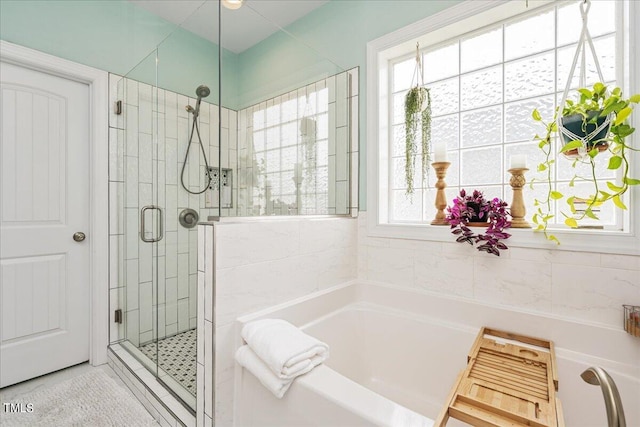 bathroom with shower with separate bathtub