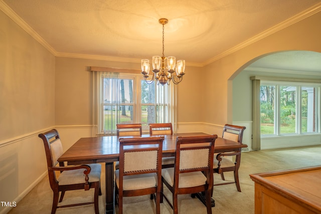 dining room with light carpet, an inviting chandelier, crown molding, and a textured ceiling