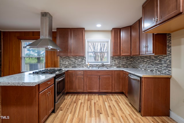 kitchen with light hardwood / wood-style floors, sink, stainless steel appliances, kitchen peninsula, and island range hood