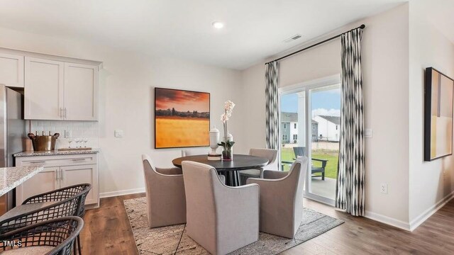 dining area with hardwood / wood-style floors