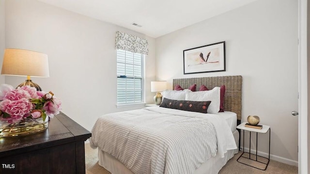 bedroom featuring light carpet