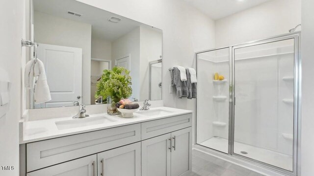 bathroom with an enclosed shower and vanity