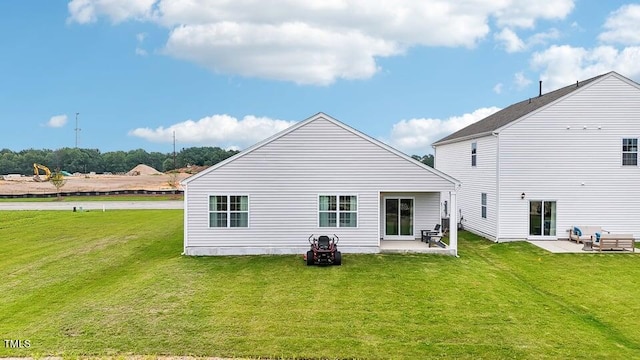 back of house with a yard and a patio