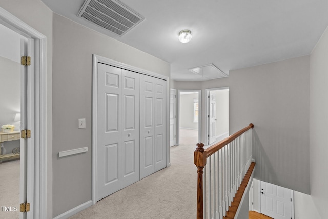 hallway featuring light carpet