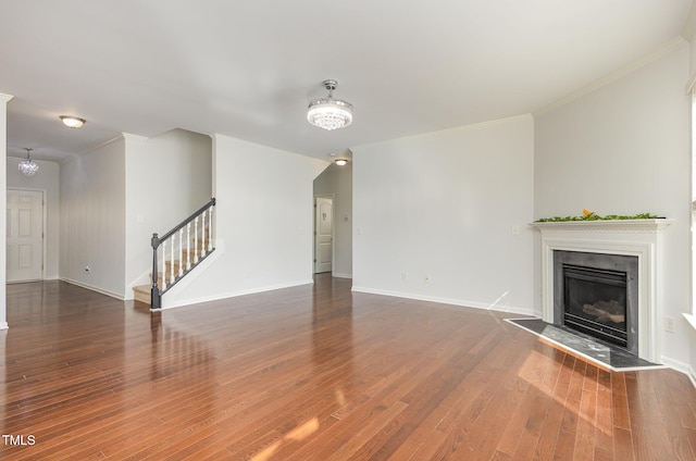 517 Birchrun Dr, Durham, NC 27712 - unfurnished living room with stairs, a chandelier, a fireplace, crown molding, and wood finished floors