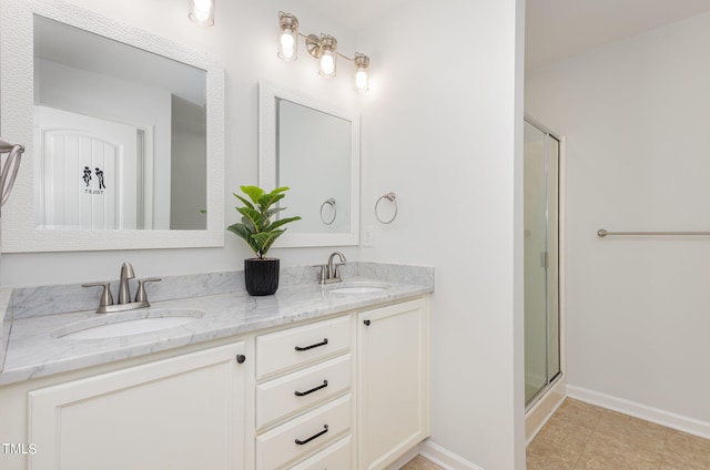 bathroom with a shower with door, tile patterned floors, and vanity