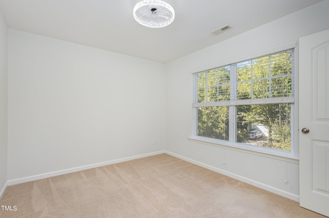 unfurnished room with light colored carpet