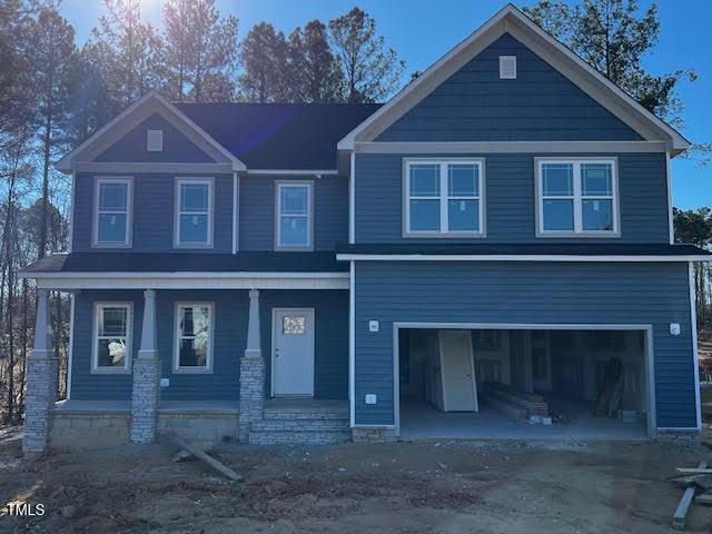 view of front of home with a garage and covered porch