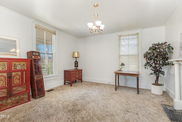 living area with crown molding, a chandelier, and carpet flooring