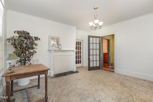 interior space featuring french doors, crown molding, and an inviting chandelier