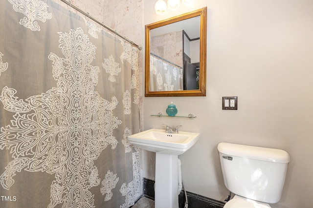 bathroom featuring toilet and a shower with shower curtain