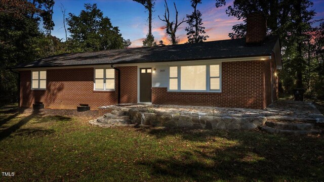 ranch-style house featuring a yard