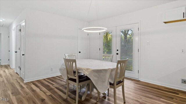 dining room with french doors and hardwood / wood-style flooring