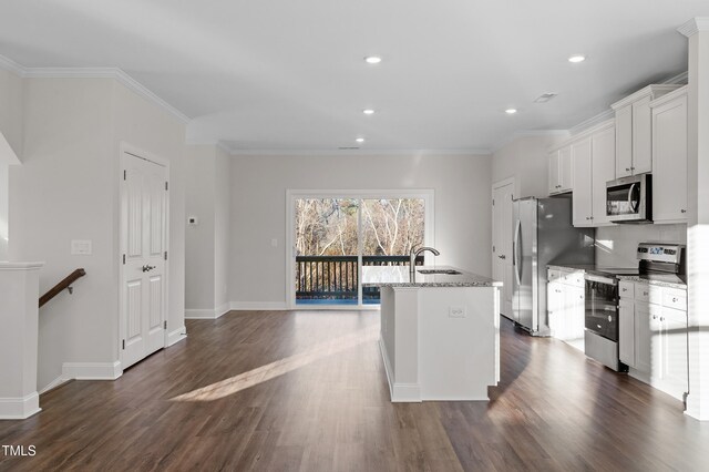 kitchen with a kitchen island with sink, dark wood-type flooring, white cabinets, light stone counters, and stainless steel appliances