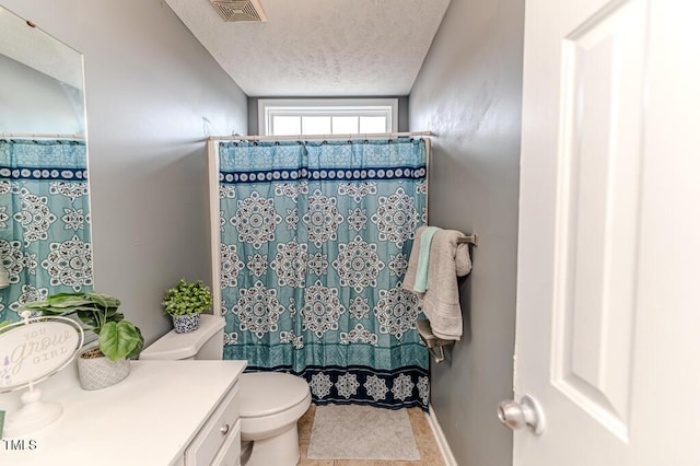 bathroom featuring vanity, toilet, a textured ceiling, and walk in shower