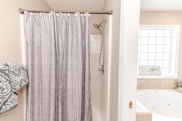 bathroom featuring shower with separate bathtub and a textured ceiling