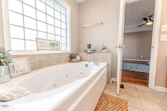 bathroom with a bathtub, tile patterned floors, and ceiling fan