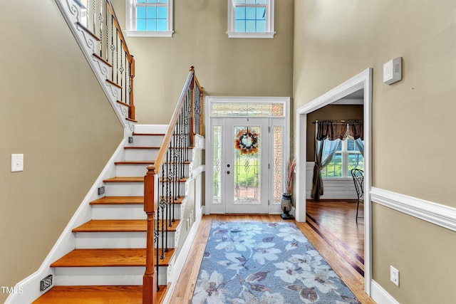 319 River Knoll Dr, Clayton, NC 27527 - foyer entrance featuring a wealth of natural light, stairway, a towering ceiling, and wood finished floors