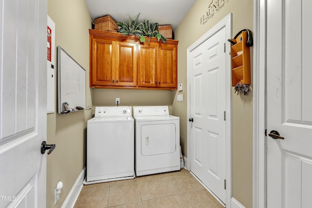 319 River Knoll Dr, Clayton, NC 27527 - laundry area featuring light tile patterned floors, baseboards, cabinet space, and washer and clothes dryer
