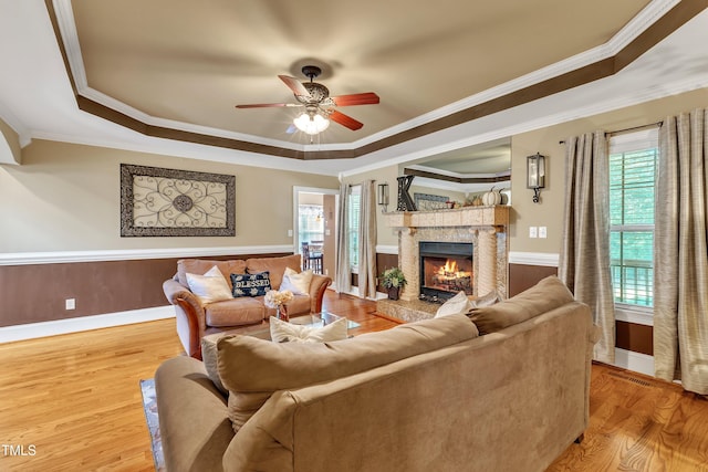 319 River Knoll Dr, Clayton, NC 27527 - living room featuring a tray ceiling, a premium fireplace, ceiling fan, and crown molding